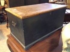 A 19thc blanket box, with painted exterior, the hinged lid above a recess with candle shelf above