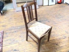 An Edwardian bedroom chair with upholstered seat on straight supports united by stretchers (85cm x