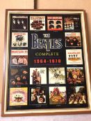 Beatlemania: a poster with Beatle Album covers and their release dates surrounding a 3D The