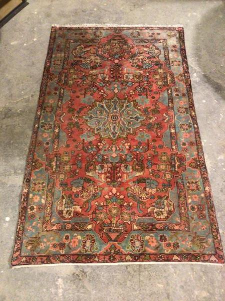 A hamadan rug, with central floral medallion surrounded by foliate design, within a light blue and
