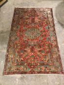 A hamadan rug, with central floral medallion surrounded by foliate design, within a light blue and