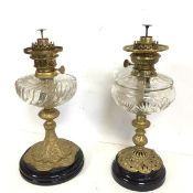 Two glass and metal oil lamps, one with gadrooned reservoir, one marked Central-Vulcan, the other