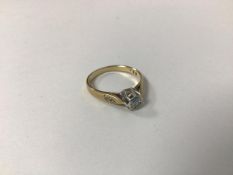 A 9ct gold ring set single diamond in pierced setting with diamond chips to shoulders (O) (2.16g)