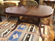 A Regency style dining table, on trestle base with downswept supports ending in paw feet, with