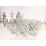 A collection of cut crystal and glass stemware including sherry glasses, wine glasses, four whisky