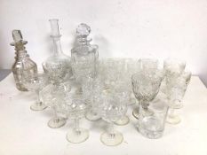 A collection of cut crystal and glass stemware including sherry glasses, wine glasses, four whisky