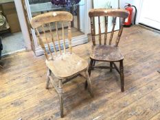 A near pair of beech and elm side chairs, each with turned spindle back above a saddle seat, on