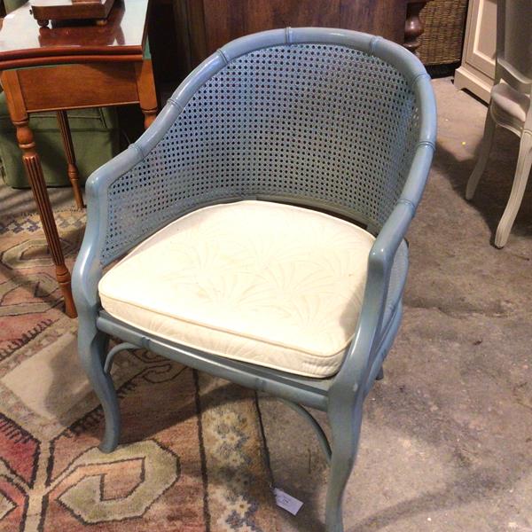 A caned curved back armchair with cane back, sides and seat, on cabriole supports, painted duck