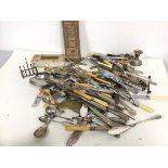 A large quantity of Epns including forks, knives, candleholders, caddy spoons, toast rack, sugar