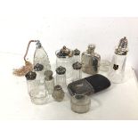 An assortment of glassware including an atomiser, a preserve jar, salts, shakers, two hip flasks,