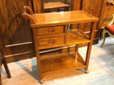 A Chinese hostess trolley with raised curved handle to one end above a chanelled top above two