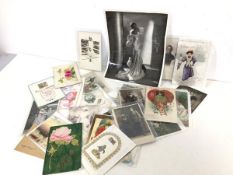 A collection of early 20thc. postcards and valentines depicting couples, sporting figures, portraits