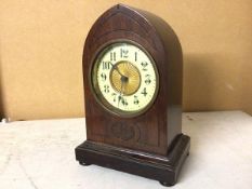 An early 20thc mahogany mantle clock with pointed top with enamel and gilt metal dial, on plinth