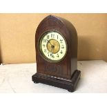 An early 20thc mahogany mantle clock with pointed top with enamel and gilt metal dial, on plinth