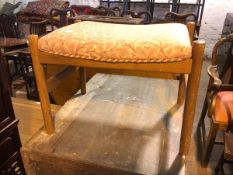 A 1960s/70s footstool with oak leaf and acorn decorated upholstered seat, on turned supports