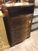 A 1930s/40s serpentine fronted chest of drawers with recess to top above five drawers (124cm x