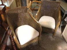 A pair of wicker armchairs, with upholstered cushion seats (89cm x 70cm x 67cm)