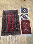 A Turkoman style hand knotted rug, with nine elephant feet medallions within multiple borders (126cm