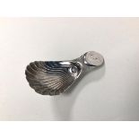 A Georgian Sheffield silver caddy spoon, makers mark N.S.... with shell bowl and initial to