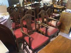 A set of eleven George III style mahogany chairs with shield backs with pierced splats, all with red
