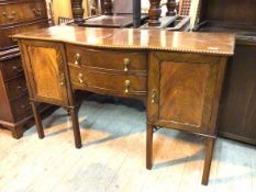 A 1920s/30s mahogany Georgian revival sideboard, with gadrooned edge and bow breakfront above two