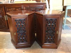 A pair of cherrywood hexagonal Chinese lamp tables with chanelled top above a carved panel door