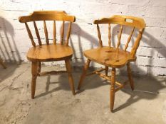 A near pair of pine side chairs, with curved spindle backs, one with a pierced top rail, on turned