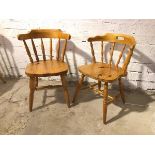 A near pair of pine side chairs, with curved spindle backs, one with a pierced top rail, on turned