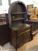 A 1930s/40s oak dresser, with domed plate rail above a base fitted two frieze drawers above two