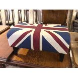 A contemporary footstool with Union Jack upholstery on ebonised square tapering supports (36cm x