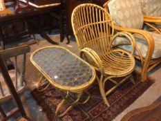 A cane verandah chair with hoop back and arms, with matching coffee table with glass tablet shaped