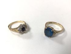 A 9ct gold cluster ring with central blue stone surrounded by clear stones, marked C.Z. (P) and