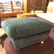 A contemporary footstool with teal upholstery (a/f), on castors (37cm x 65cm x 47cm)