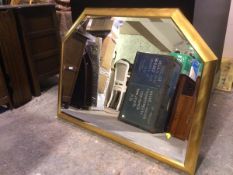 A contemporary wall mirror with bevelled glass within gilt frame with canted top corners (88cm x