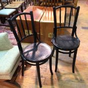 A pair of 1920s/30s Polish bistro ebonised chairs, both with floral relief decoration to seat,