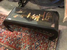 A Chinese hardwood low table, the top with scene depicting Figures on a Verandah, the decoration