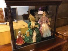 A 1920s/30s display cabinet with a collection of dolls including a wooden doll with a Costumes by