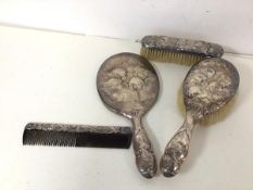 An Edwardian London silver dressing table set with hand mirror (28cm), hair brush, clothes brush and