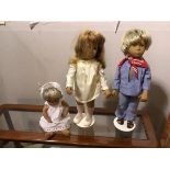 A collection of three Sasha dolls, including a Young Boy and Girl on stands, also Infant in