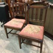 A pair of Georgian mahogany side chairs with spar backs and slip in seats raised on square tapered