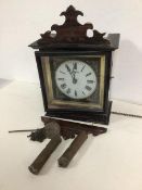 An Edwardian wall clock with painted glass dial and roman numerals, complete with weights and