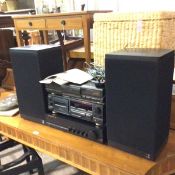 A pair of Kef Celestial speakers, a Harman-Kardon integrated amplifer, a Technics digital stereo