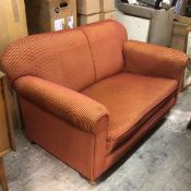 A 1920s two piece lounge suite comprising an upholstered easy chair and two seater drop end sofa