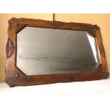 A 1920s/30s oak rectangular wall mirror, the bevelled glass with canted edges (51cm x 81cm)