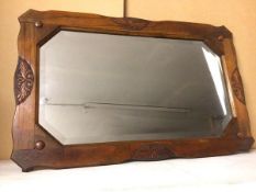A 1920s/30s oak rectangular wall mirror, the bevelled glass with canted edges (51cm x 81cm)