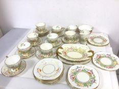A 1930s Royal Stafford teaset, including nine teacups, saucers, side plates, serving plates, milk