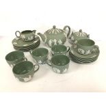 A Wedgwood green jasparware teaset including teapot (12cm x 23cm x 15cm), six teacups and saucers,