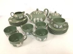 A Wedgwood green jasparware teaset including teapot (12cm x 23cm x 15cm), six teacups and saucers,