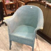 A Lloyd Loom teal blue painted basket chair with splay arms on turned splay supports (78cm x 68cm