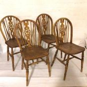 A set of four ash Windsor style pierced splat back and spindle back kitchen dining chairs with